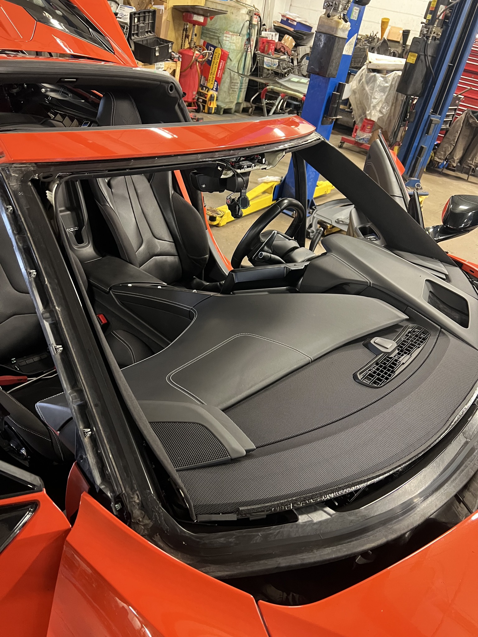 Orange Corvette C8 interior with windshield removed during replacement at B-Rite
